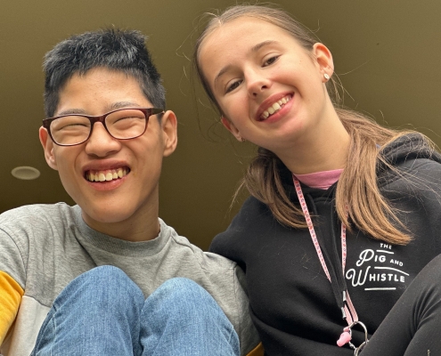 Volunteer and participant sitting and smiling